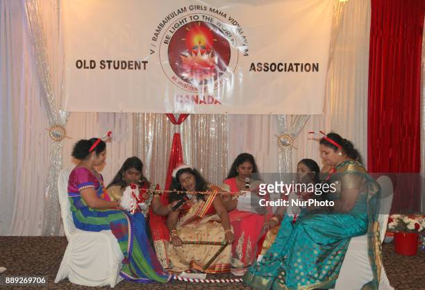 Tamil women singing Christmas songs while hitting a string with jingle bells during the V Rambaikulam Girls Maha Vidyalayam Old Students Association...