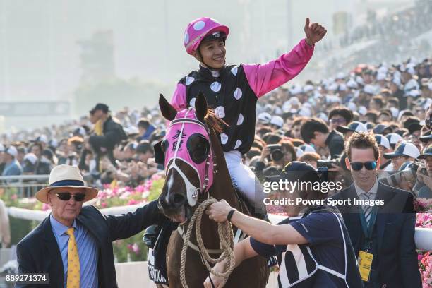 Jockey Derek K C Leung riding Beauty Generation celebrates with trainer John Moore after winning the Longines Hong Kong Mile during the Longines Hong...