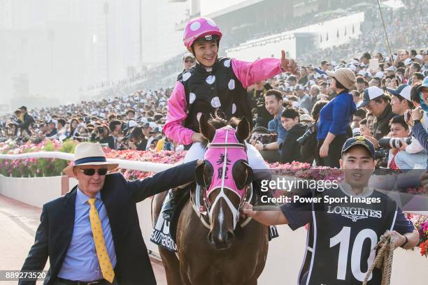 Jockey Derek K C Leung riding Beauty Generation celebrates with trainer John Moore after winning the Longines Hong Kong Mile during the Longines Hong...