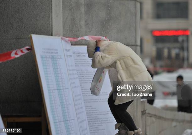 Canditate walks to an exam site before China's national civil servant exam on December 10, 2017 in Harbin, Heilongjiang province of China....