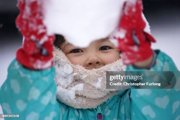 Emily Warrington, aged four, experiences snow and makes her first ever snowball outside her home on December 10 in Stoke On Trent, United Kingdom....