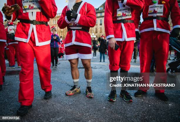 Charity runners dressed as Father Christmas participate in the 'Santa Run' charity fun run in Stockholm on December 10, 2017. Hundreds of...