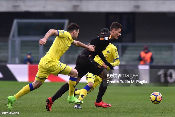 Patrick Schick of Roma holds off the challenge from Nenan Tomovic of Chievo Verona during the Serie A match between AC Chievo Verona and AS Roma at...