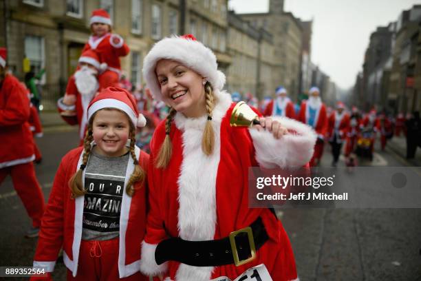 Over eight thousand members of the public take part in Glasgow's annual Santa dash make their way along St Vincent Street on December 10, 2017 in...