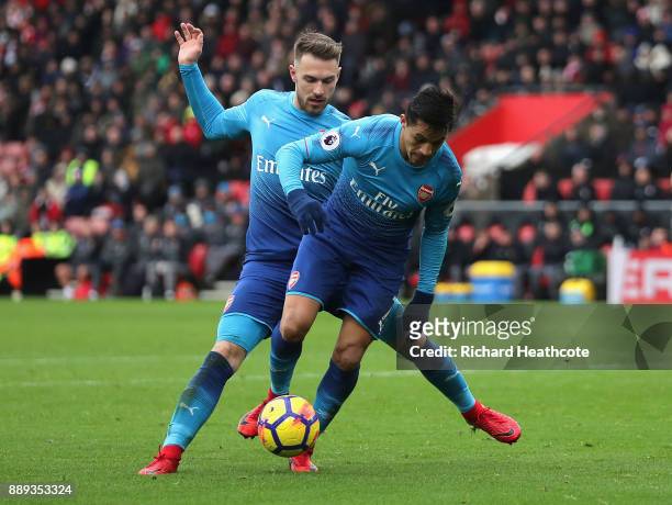 Alexis Sanchez and Aaron Ramsey of Arsenal clash during the Premier League match between Southampton and Arsenal at St Mary's Stadium on December 9,...
