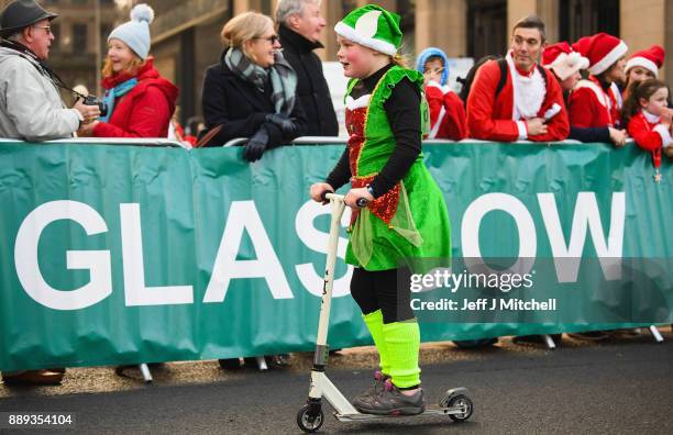 Over eight thousand members of the public take part in Glasgow's annual Santa dash make their way along St Vincent Street on December 10, 2017 in...