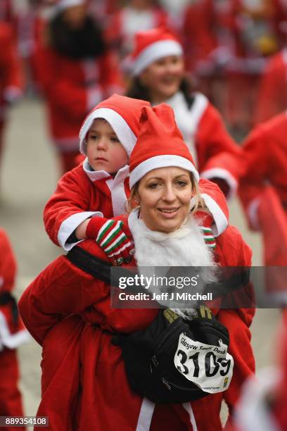 Over eight thousand members of the public take part in Glasgow's annual Santa dash make their way up St Vincent Street on December 10, 2017 in...