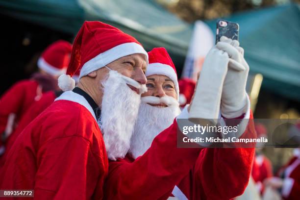 Participants in the Stockholm Santa Run take a selfie at Kungstradgarden on December 10, 2017 in Stockholm, Sweden. The Stockholm Santa Run is an...