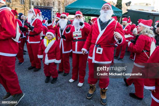 Participants in the Stockholm Santa Run warming up at Kungstradgarden on December 10, 2017 in Stockholm, Sweden. The Stockholm Santa Run is an annual...