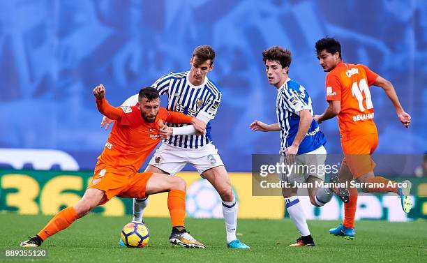 Diego Llorente of Real Sociedad duels for the ball with Borja Gonzalez of Malaga CF during the La Liga match between Real Sociedad de Futbol and Real...