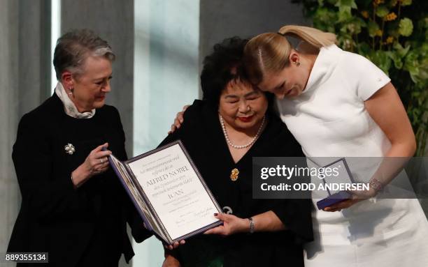 Berit Reiss-Andersen , chairperson of the Norwegian Nobel Committee, hands over the 2017 Nobel Peace Prize to Beatrice Fihn , leader of ICAN , and...