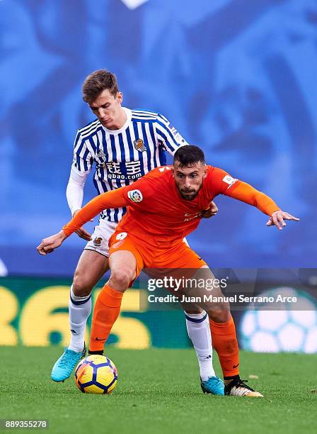 Diego Llorente of Real Sociedad duels for the ball with Borja Gonzalez of Malaga CF during the La Liga match between Real Sociedad de Futbol and Real...