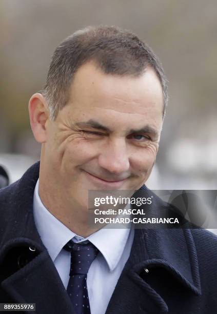 Candidate for the Pe a Corsica nationalist party for territorial electiond Gilles Simeoni gestures as he walks ahead of casting his vote in a polling...