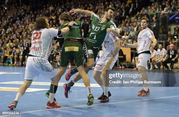 Timm Schneider of MT Melsungen, Erik Schmidt, Petar Nenadic of Fuechse Berlin and Johannes Golla of MT Melsungen during the DKB Handball Bundesliga...