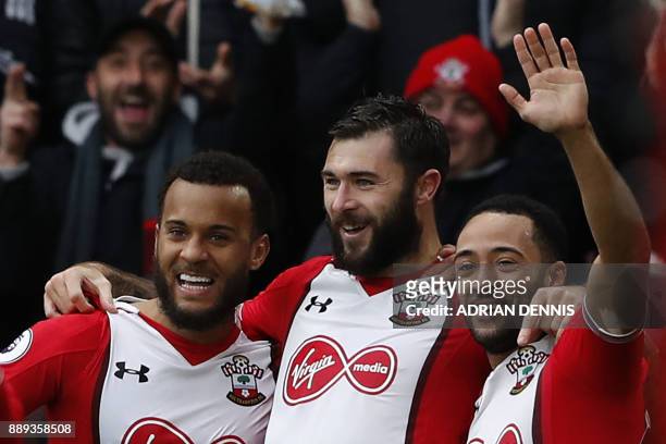 Southampton's English striker Charlie Austin celebrates scoring the team's first goal with Southampton's English defender Ryan Bertrand and...