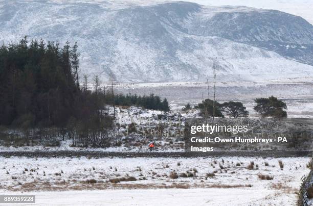 Man cycles in Middleton in Teesdale, Durham, as heavy snowfall across parts of the UK is causing widespread disruption, closing roads and grounding...