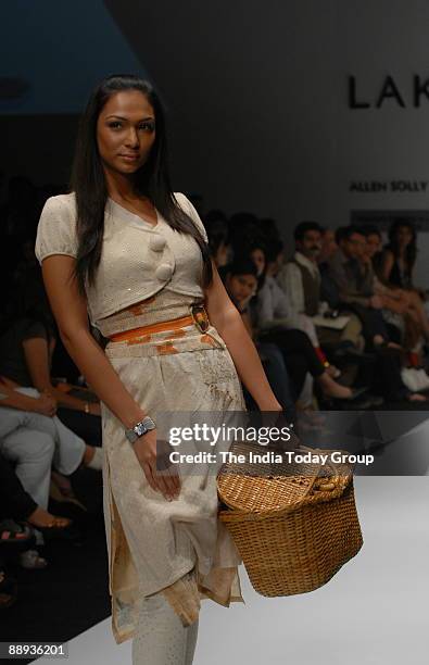 Model is walking on the ramp with Fashion designer Agnimitra Paul outfit at Lakme Fashion Week Spring Summer-2007 in Mumbai, Maharashtra, India )