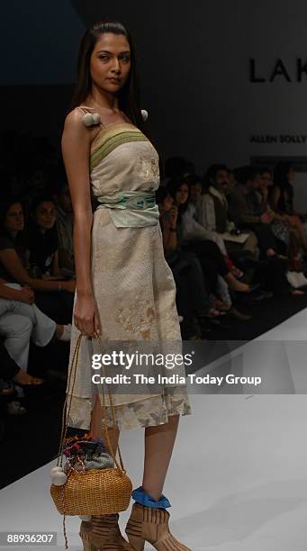 Model is walking on the ramp with Fashion designer Agnimitra Paul outfit at Lakme Fashion Week Spring Summer-2007 in Mumbai, Maharashtra, India )