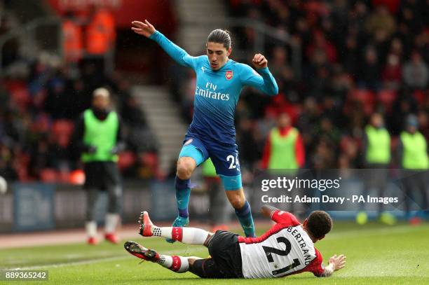 Arsenal's Hector Bellerin jumps over Southampton's Ryan Bertrand during the Premier League match at St Mary's Stadium, Southampton.