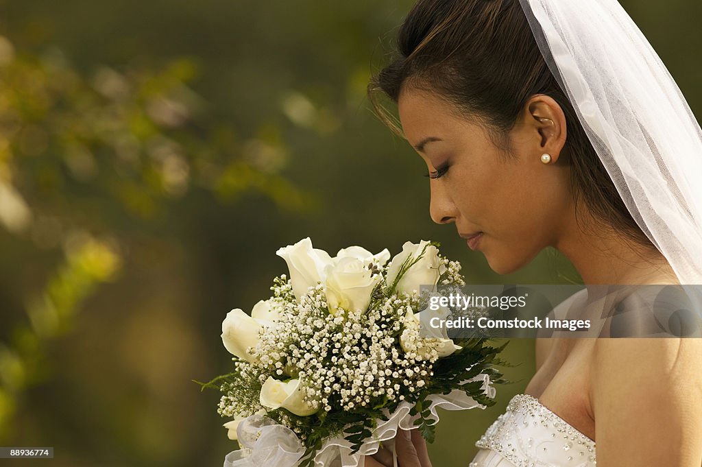 Bride smelling flowers