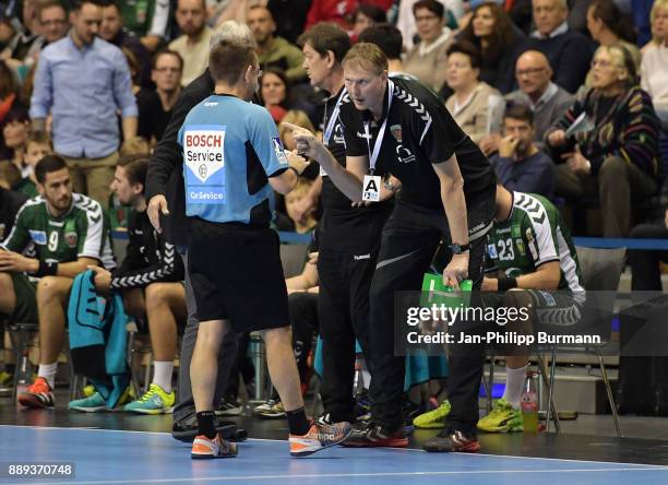 Referee Peter Behrens and Volker Zerbe of Fuechse Berlin argue during the game between Fuechse Berlin and dem MT Melsungen on december 10, 2017 in...