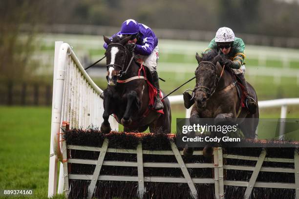 Ireland - 10 December 2017; Aa Bee See with Mark Walsh up jump the last ahead of Mary Frances with Robbie Power up on their way to winning the 3 For...