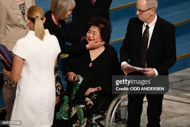 Beatrice Fihn , leader of ICAN , and Norwegian Nobel Committee member Henrik Syse look on as Nobel Committee member Tone Jorstad comforts Hiroshima...