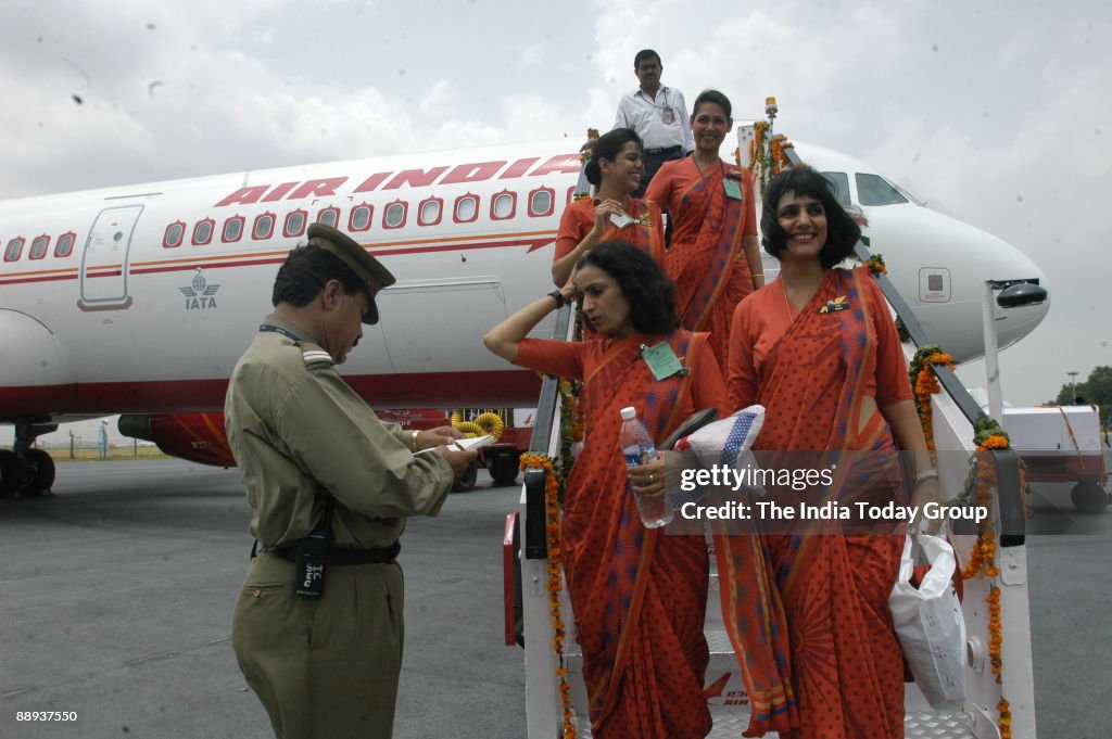 Air India air hostesses, wear their new uniform atop the Air India flight, during the delivery of the Boeing 737-800 VT-AXH to its own fleet at Indira Gandhi International Airport in New Delhi, India ( Air India-Express, Aeroplane, Indian Airline, Inaugur