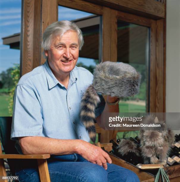 American actor and winemaker Fess Parker holding a coonskin cap at the Fess Parker Family Winery and Vineyards in Los Olivos, California, circa 2000.