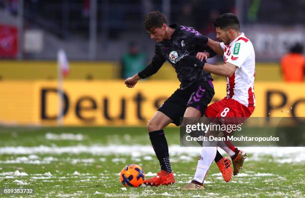 Pascal Stenzel of SC Freiburg and Milos Jojic of FC Koeln battle for the ball during the Bundesliga match between 1. FC Koeln and Sport-Club Freiburg...