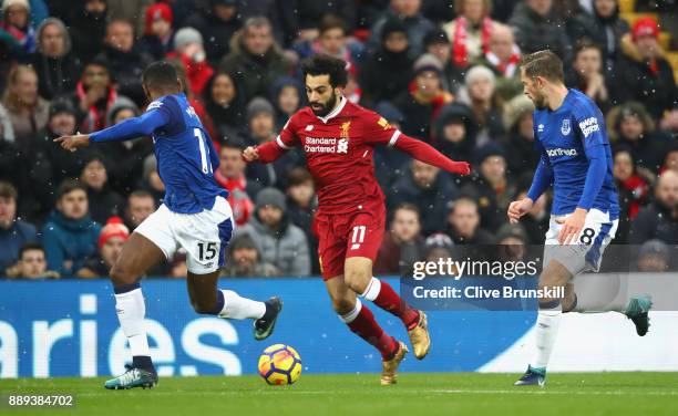 Mohamed Salah of Liverpool is chased by Gylfi Sigurdsson and Cuco Martina of Everton during the Premier League match between Liverpool and Everton at...