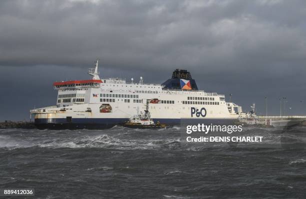 Tugboats manouver the P&O ferry MS "Pride of Kent" which ran aground in the harbour of the port of Calais on December 10, 2017. - A ferry with more...