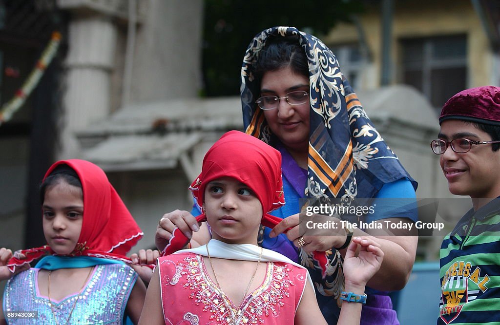 A Parsi women preparing her children before entering at the fire temple on the occasion of Navroze - the Parsi New Year in Mumbai, 20 August 2007. Parsis, followers of Zoroastrianism, a small religious community which exists mostly in Mumbai, were exiled