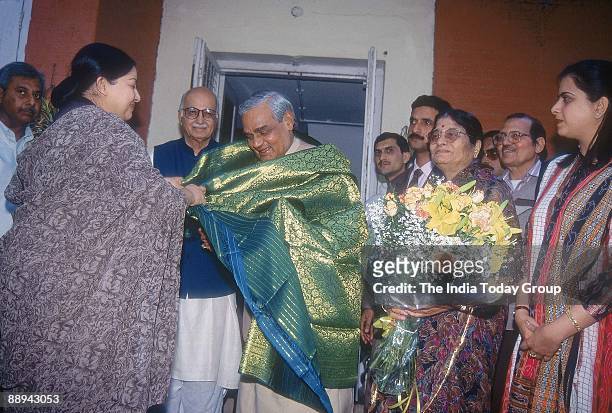 Atal Bihari Vajpayee being felicitated with a shawl by J Jayalalitha and Lal Krishna Advani looking