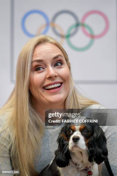 Ski star Lindsey Vonn smiles as she holds her dog under the Olympic Rings during a press conference after she was appointed ski ambassador of the...