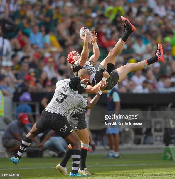 Sam Myers of Australia and Kalione Nasoko of Fiji during day 2 of the 2017 HSBC Cape Town Sevens at Cape Town Stadium on December 10, 2017 in Cape...