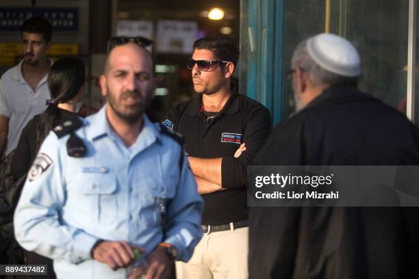 Israeli Police officers and security guard are seen at the scene of an attack at the Jerusalem Central Bus Station on December 10, 2017 in Jerusalem,...