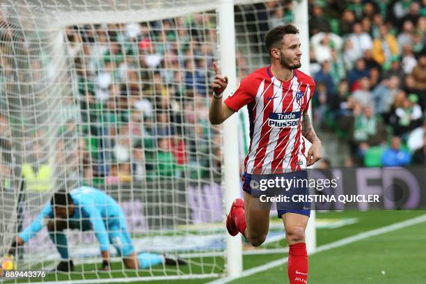 Atletico Madrid's Spanish midfielder Saul Niguez celebrates after scoring a goal during the Spanish league football match between Real Betis and...