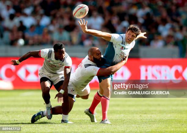 France's Jeremy Aicardi is tackled by Malon Aljibori of the US during their match on the second day of the World Rugby Sevens Series at Cape Town...