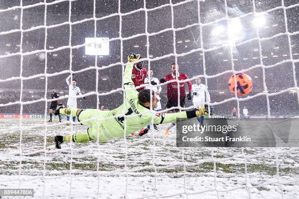 Martin Harnik of Hannover 96 scores with team's second goal against Oliver Baumann of 1899 Hoffenheim to make it 2-0 during the Bundesliga match...