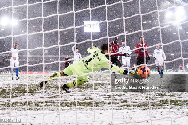 Martin Harnik of Hannover 96 scores with team's second goal against Oliver Baumann of 1899 Hoffenheim to make it 2-0 during the Bundesliga match...