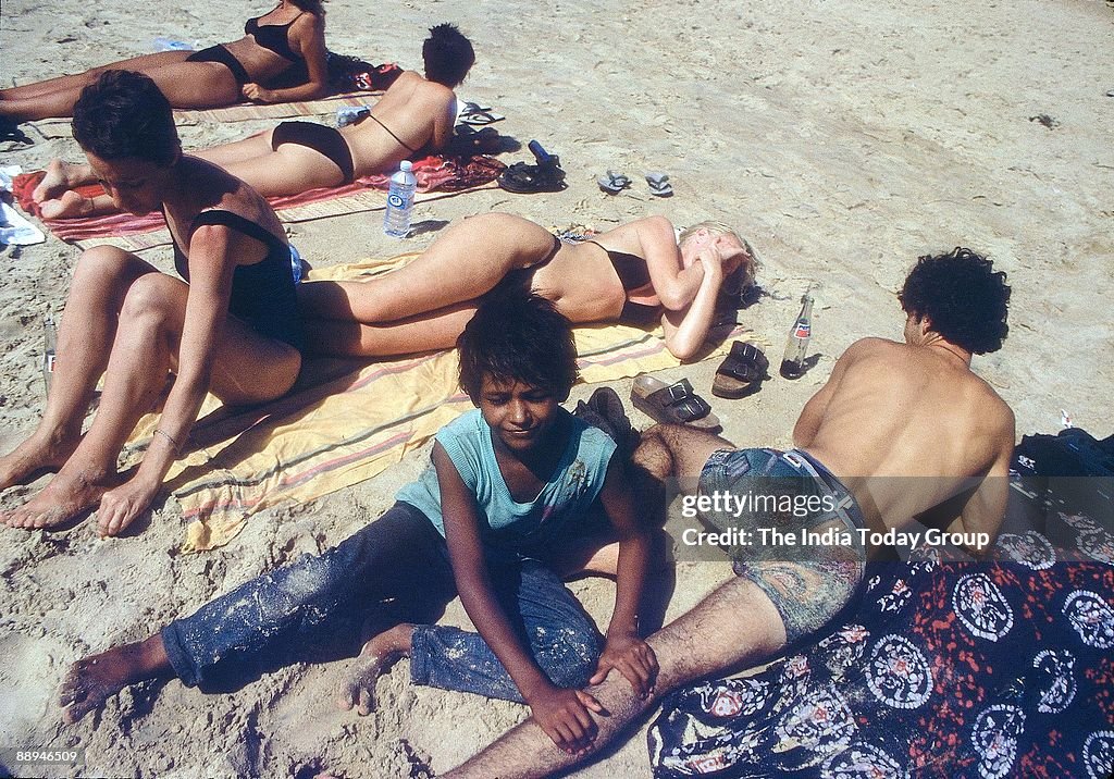 Young Child providing services to Foreign Tourist at Goa Beach ( Child Labour, News Profile )