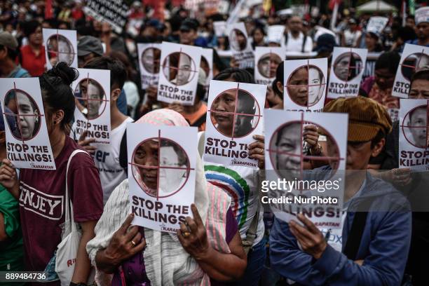 Protesters hold up pictures of victims of extrajudicial killings during Human Rights Day protests in Manila, Philippines, December 10, 2017. On...