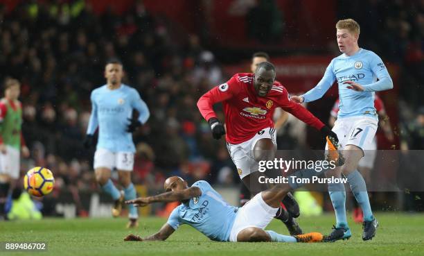 Romelu Lukaku of Manchester United in action with Fabian Delph and Kevin de Bruyne of Manchester City during the Premier League match between...