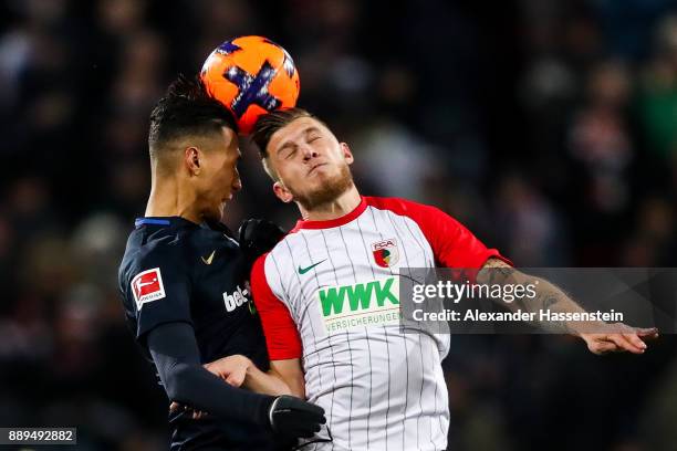 Davie Selke of Hertha Berlin and Jeffrey Gouweleeuw of Augsburg battle for the ball during the Bundesliga match between FC Augsburg and Hertha BSC at...