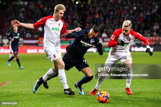 Philipp Max of Augsburg , Davie Selke of Hertha Berlin and Martin Hinteregger of Augsburg battle for the ball during the Bundesliga match between FC...