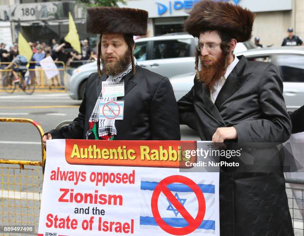 Ultra-Orthodox Jewish Rabbis hold signs denouncing Israel during a demonstration in Toronto, Canada on July 29, 2017. Muslims and Jews came together...