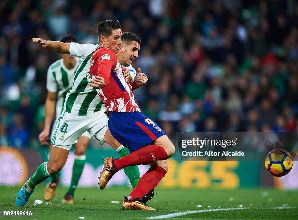 TFernando Torres of Club Atletico de Madrid competes for the ball with Zouhair Feddal of Real Betis Balompie during the La Liga match between Real...