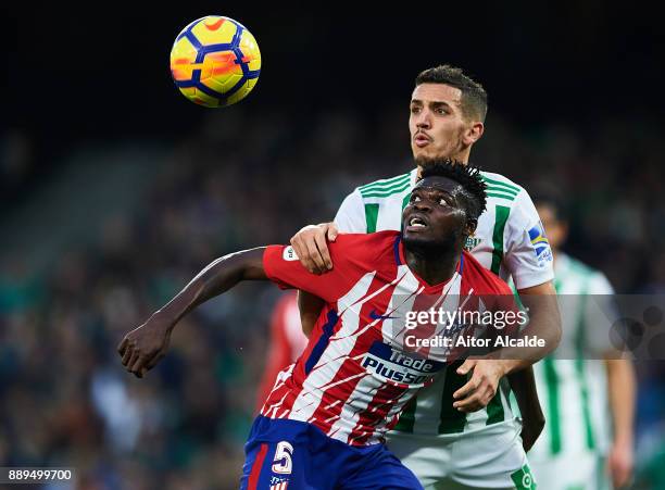 Thomas Partey of Club Atletico de Madrid competes for the ball with Zouhair Feddal of Real Betis Balompie during the La Liga match between Real Betis...