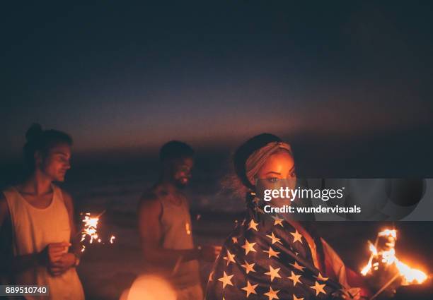 young multi-ethnic hipster friends celebrating fourth of july with sparklers - american flag fireworks stock pictures, royalty-free photos & images